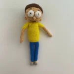 Morty Smith in an adventurous pose, perhaps running or looking surprised, as seen in Rick and Morty - amigurumi inspiration by Sage & Silky.
