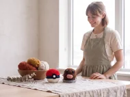 diglett reversible crochet pattern — the finished Diglett plush and its crocheted ball on a linen covered table in the studio