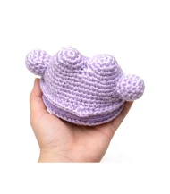 Ditto reversible crochet pattern — the finished plush held in a hand to show its real size