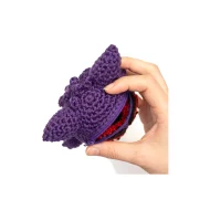 Gengar reversible crochet pattern — the finished plush held in a hand to show its real size