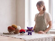 gengar reversible crochet pattern — the finished Gengar plush and its crocheted ball on a linen covered table in the studio