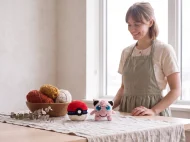 jigglypuff reversible crochet pattern — the finished Jigglypuff plush and its crocheted ball on a linen covered table in the studio