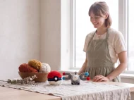 magnemite reversible crochet pattern — the finished Magnemite plush and its crocheted ball on a linen covered table in the studio