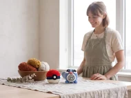 poliwag reversible crochet pattern — the finished Poliwag plush and its crocheted ball on a linen covered table in the studio
