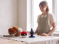 shuppet reversible crochet pattern — the finished Shuppet plush and its crocheted ball on a linen covered table in the studio