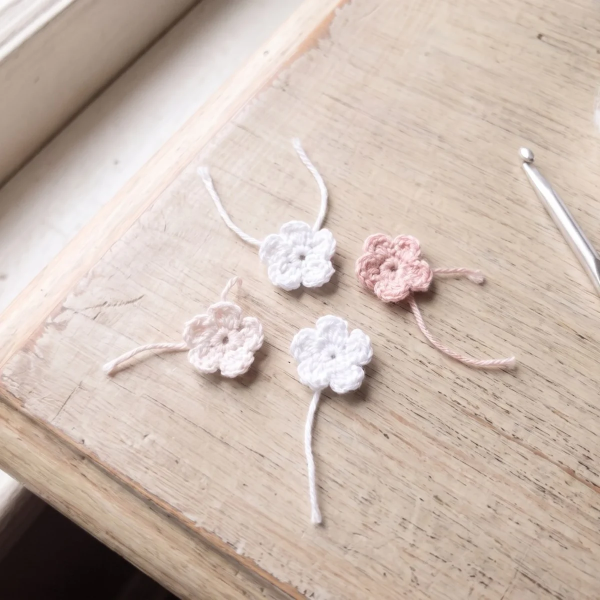 Five tiny crocheted flowers from the crochet angel ornament pattern rose crown