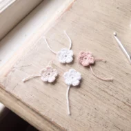 Five tiny crocheted flowers from the crochet angel ornament pattern rose crown