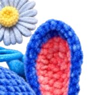 ear inner texture and daisy keyring charm close-up from the crochet blue alien pattern