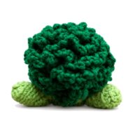 Close-up back view of the dark-green surface-crochet floret crown on the crochet broccoli pattern amigurumi, arms visible