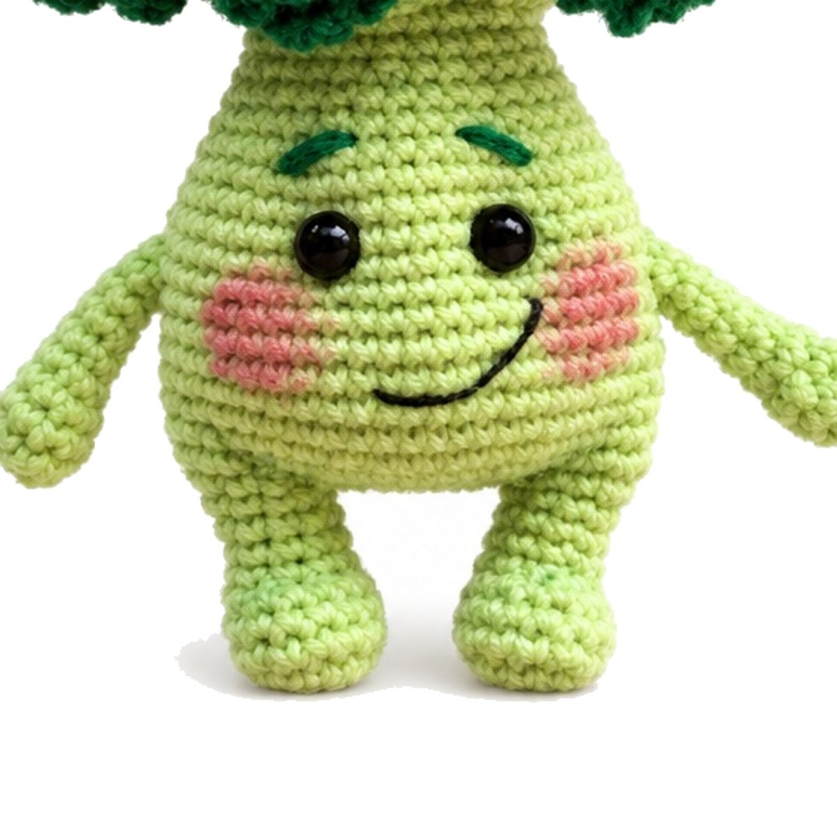 Close-up of the crochet broccoli pattern amigurumi showing face, blushed cheeks, horizontal body stitches and rounded legs