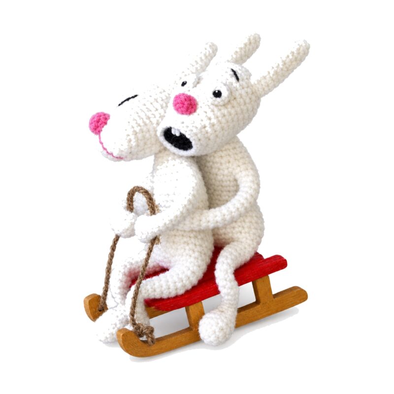 The crochet bunnies on sled pattern seen from a second angle, holding the jute rope harness
