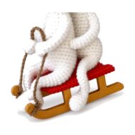 The sled detail from the crochet bunnies on sled pattern, showing the red seat and wood-tone runners