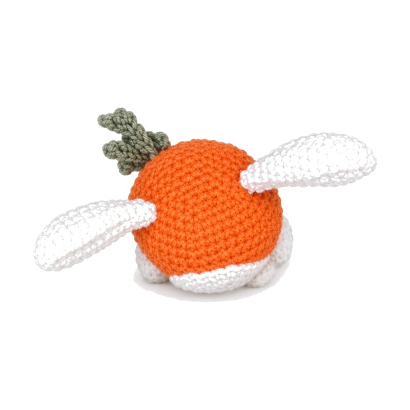 Side view of the finished crochet bunny carrot pattern toy showing the white face disc, bead eye, embroidered nose and white arm