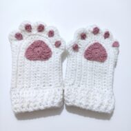 The finished pair from the crochet cat paw gloves pattern, cream gloves with dusty-rose paw pads and toe pads