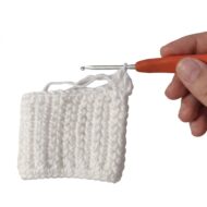 Working the ribbed wrist cuff of the crochet cat paw gloves pattern around the stitch posts