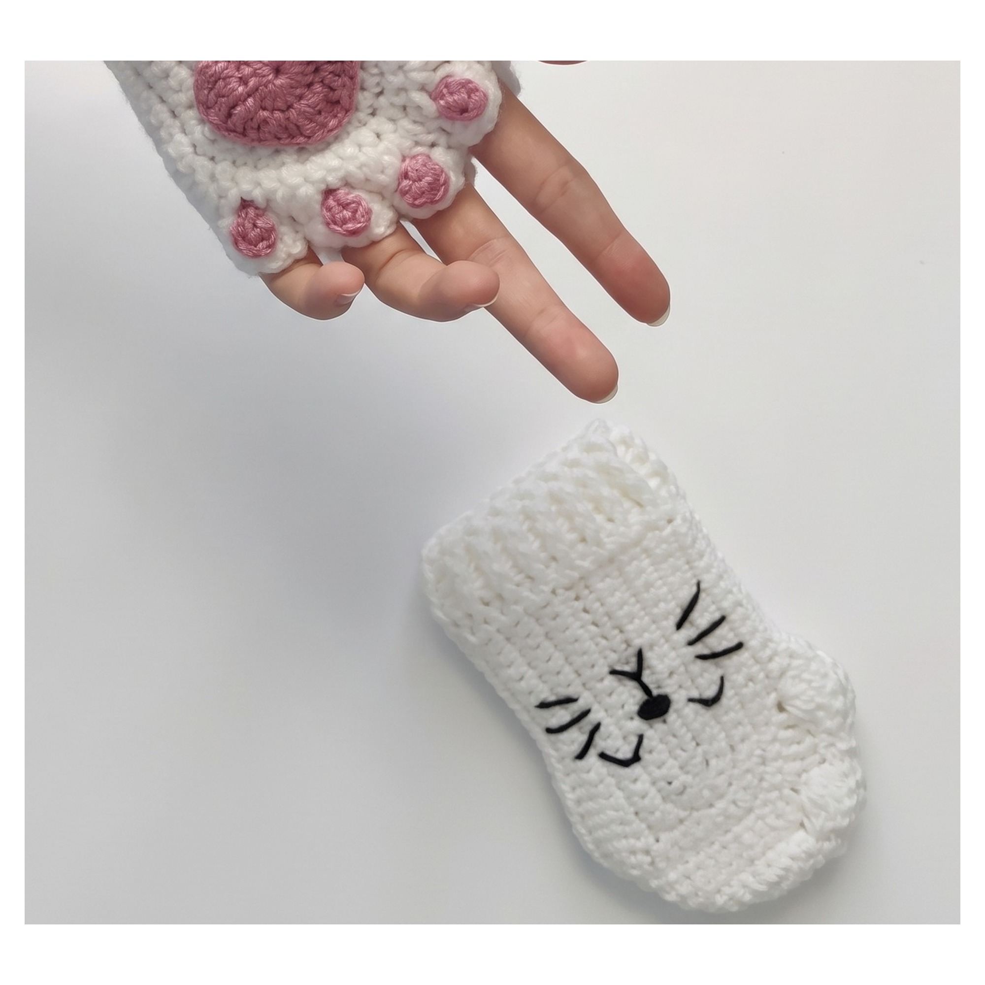 The embroidered black cat face from the crochet cat paw gloves pattern