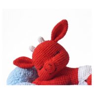 Close-up of the head, white horns and long ears from the crochet devil pattern