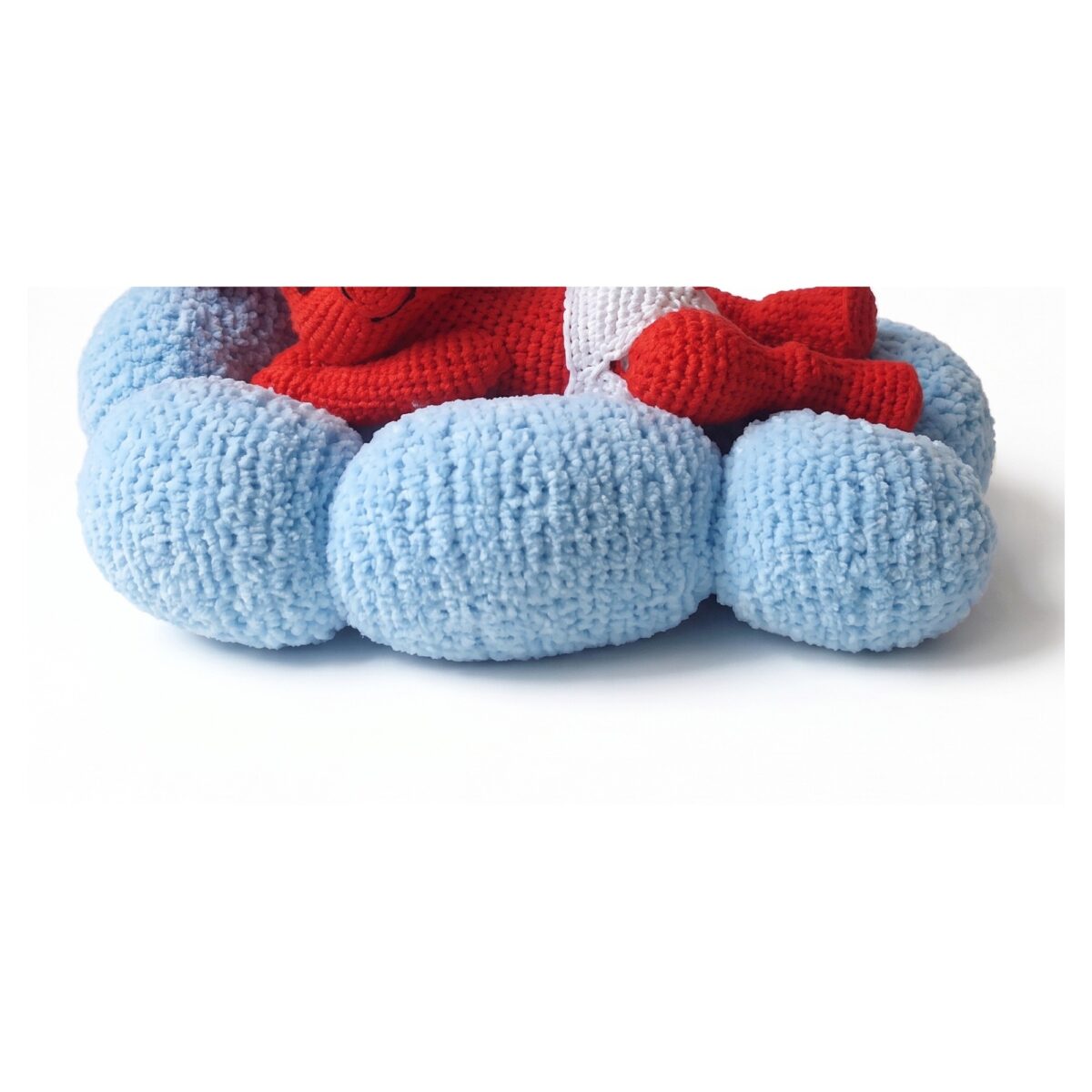 Detail of the fluffy knitted cloud from the crochet devil pattern, quilted between its three rolls