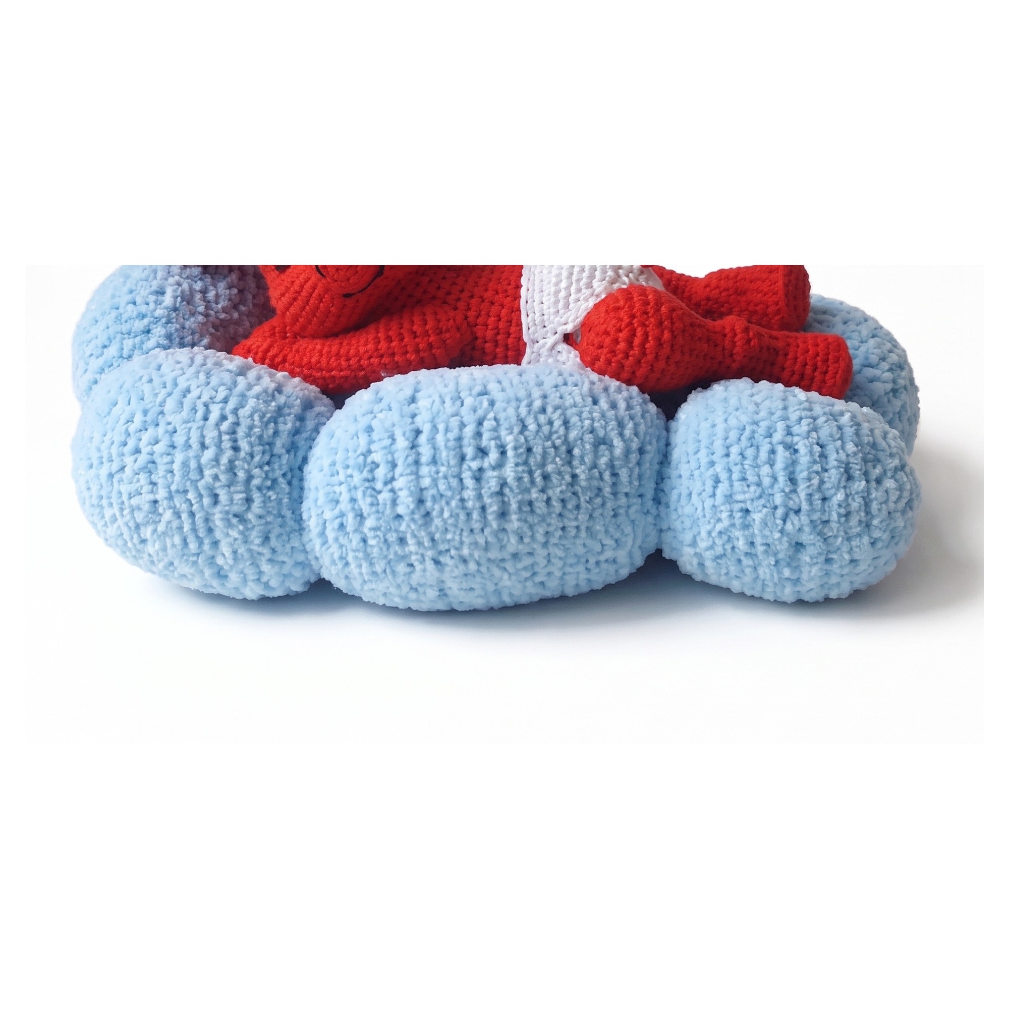 Detail of the fluffy knitted cloud from the crochet devil pattern, quilted between its three rolls