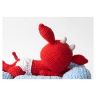 The red crocheted devil in close-up on his cloud, from the crochet devil pattern