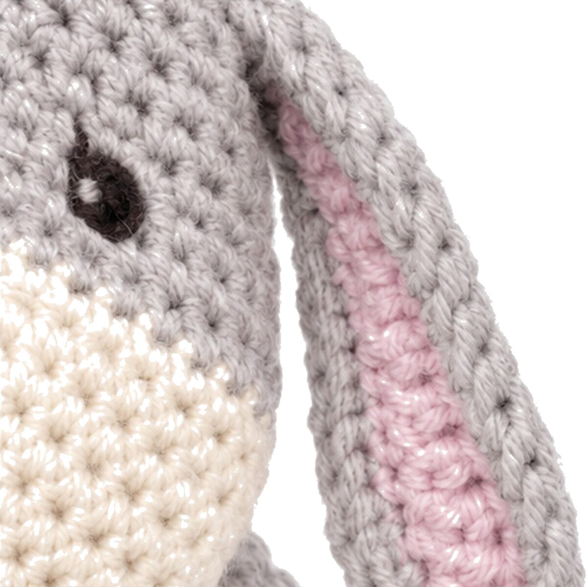 The crochet donkey pattern's ear, grey outer and pink inner lining, on the finished head