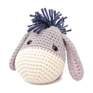 Close-up of the crochet donkey pattern's face, with its cream muzzle band and safety eyes