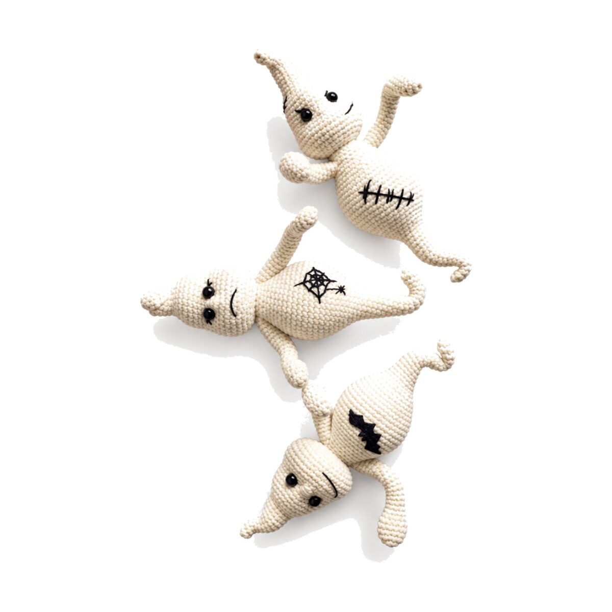 Three crochet ghost pattern amigurumi toys in smiling, frowning and stitched-scar moods