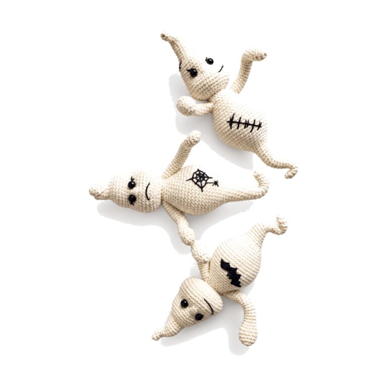 Three crochet ghost pattern amigurumi toys in smiling, frowning and stitched-scar moods