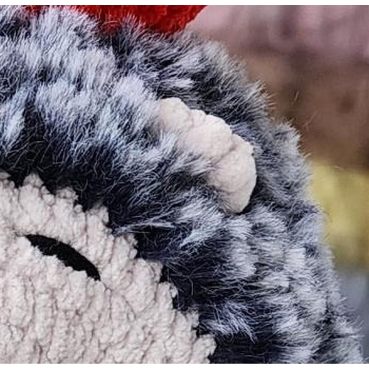 Detail of the fluffy fur-yarn spines and the ear from the crochet hedgehog pattern