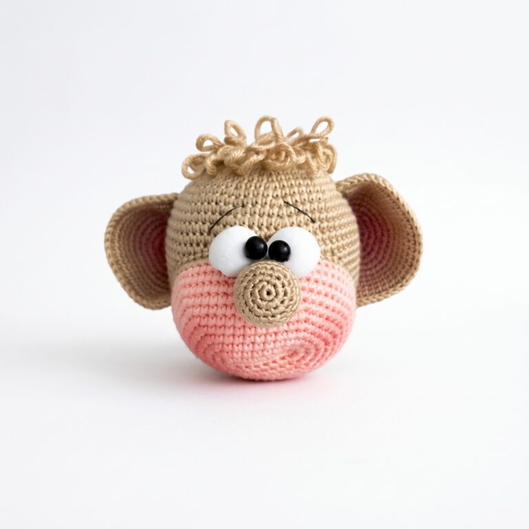 The monkey head with its loop-stitch fringe and pink-lined ears from the crochet monkey pattern