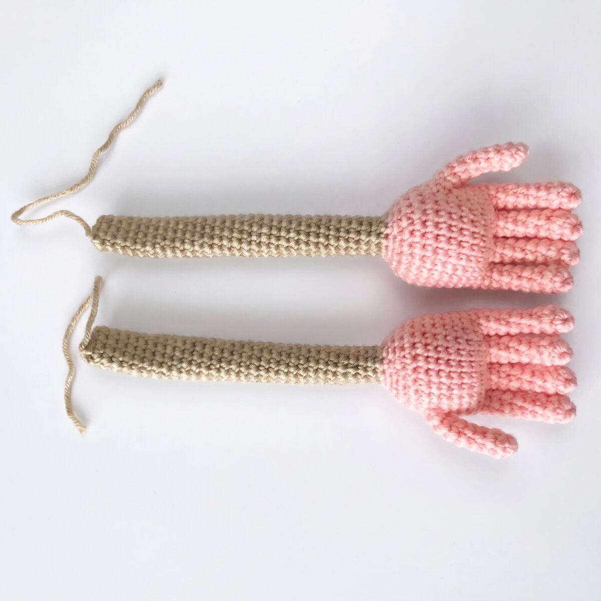 Both arms with their five-fingered hands from the crochet monkey pattern