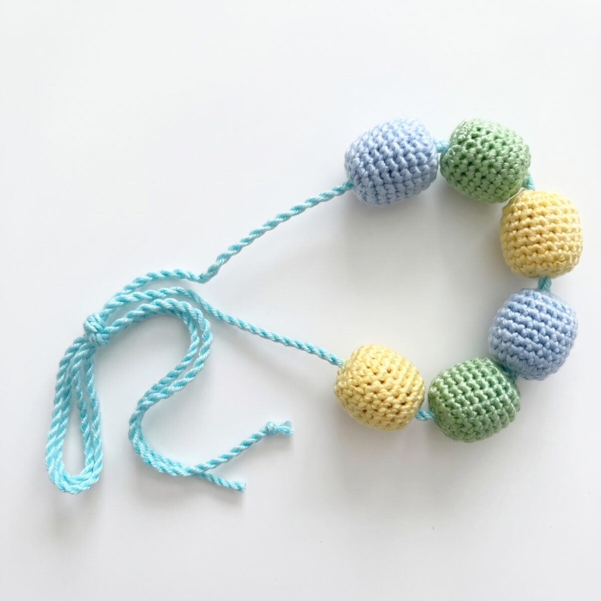 The crocheted wooden bead necklace that comes with the crochet monkey pattern