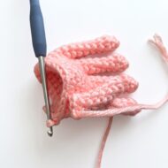 Joining the five separate fingers into one hand, from the crochet monkey pattern